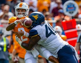 CHARLOTTE, NC - SEPTEMBER 01: Tennessee Volunteers quarterback Jarrett Guarantano (2) is hit by West Virginia Mountaineers defensive lineman Kenny Bigelow Jr. (40) for fumble on the first play of the Belk College Kickoff between the West Virginia Mountaineers and the Tennessee Volunteers on September 1, 2018, at the Bank of America Stadium in Charlotte, North Carolina. (Photo by Jay Anderson/Icon Sportswire)
