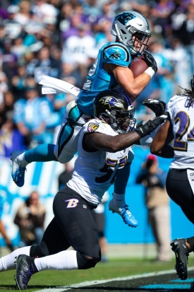 CHARLOTTE, NC - OCTOBER 28: Carolina Panthers running back Christian McCaffrey (22) makes a leaping catch for a touchdown over Baltimore Ravens inside linebacker C.J. Mosley (57) on October 28, 2018, at Bank of America Stadium in Charlotte, NC. (Photo by Jay Anderson/Icon Sportswire)