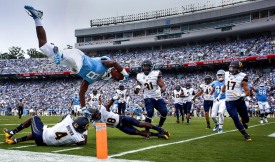 September 2, 2017; Kenan Memorial Stadium, Chapel Hill, North Carolina, USA; Football: University of North Carolina Tarheels tailback Michael Carter (8) leaps into the end zone for a touchdown in the first half against the California Golden Bears. Photo credit: Jay Anderson - KLC fotos