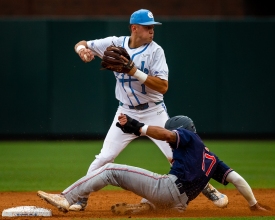 CHAPEL HILL, NC - JUNE 8: North Carolina Tar Heels shortstop Danny Serretti (1) turns a double play as Auburn Tigers infielder Will Holland (17) tries to break it up during the first game of NCAA Super Regional on June 8, 2019, at Boshamer Stadium in Chapel Hill, NC. (Photo by Jay Anderson/College Baseball Daily)